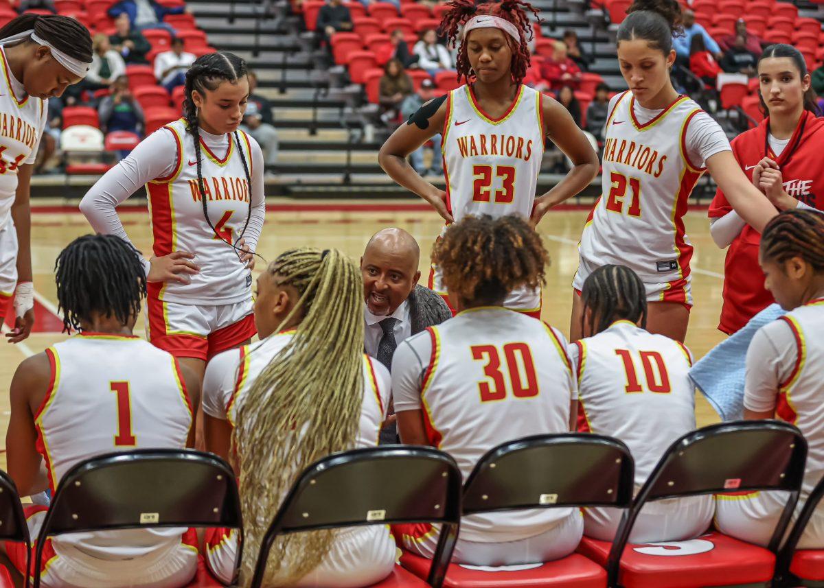 Wayman Strickland talking to players on sideline during their game. (Photo courtesy of the Womens Basketball Team players)
