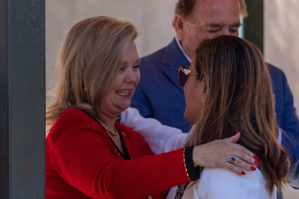 President Britt Rios-Ellis embraces a student at the reception after her welcome address. (Signal Photo/Nathan Hartwell)