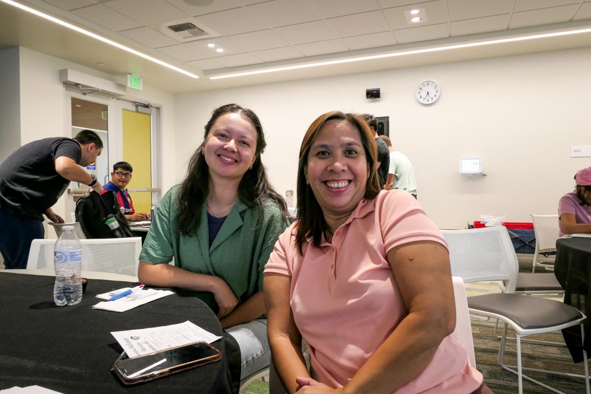 Cecilia Ramirez (Accounting, senior) and Catherine Rambongga (Master of Business Administration, first year) networking with students and alumni at Warriors Welcoming Warriors. 