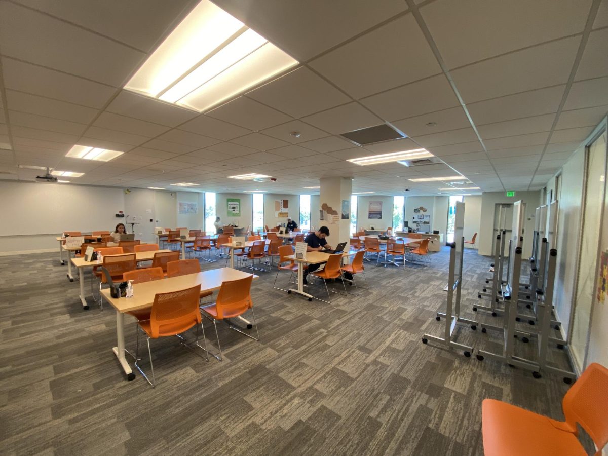 Students working at tables inside the Tutoring Center.