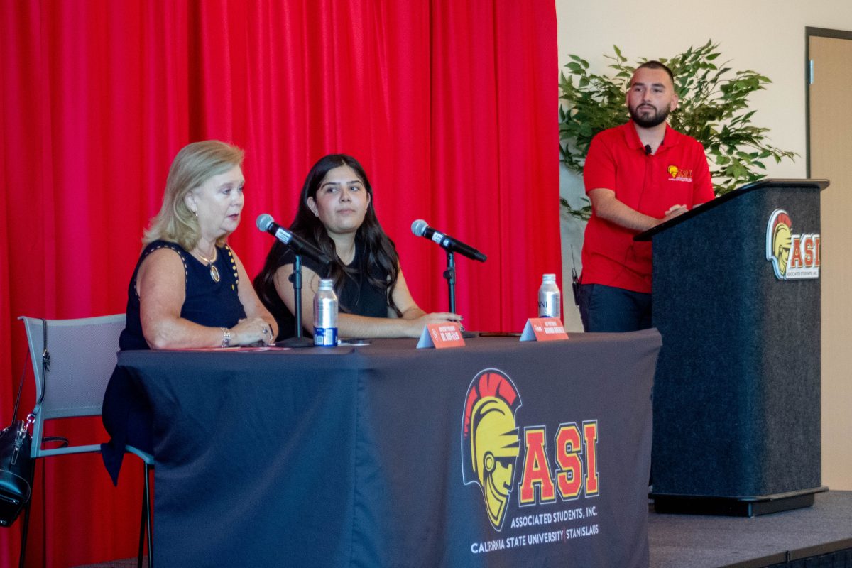 President Britt Rios-Ellis and President Miranda Gonzalez answer questions from students with Adrian Sanchez standing in the background as he moderates questions. 