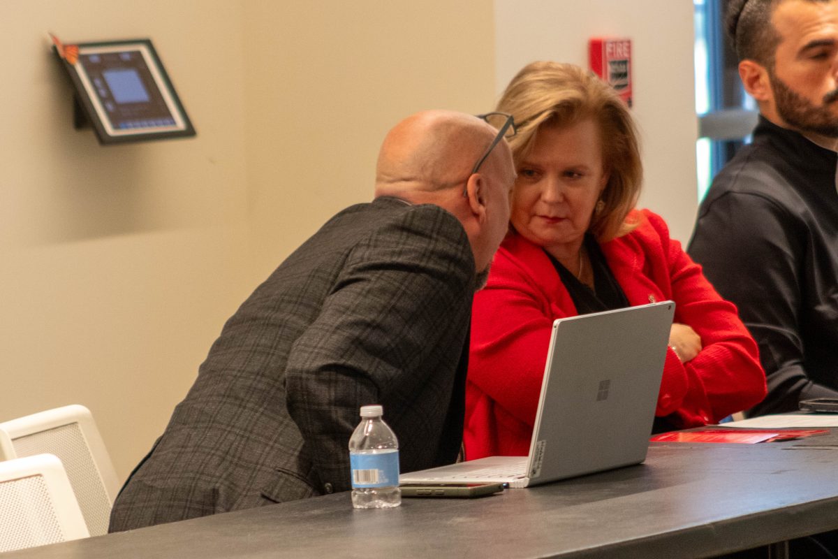 Provost Richard Ogle consults with President Britt Rios-Ellis during today's Academic Senate session.