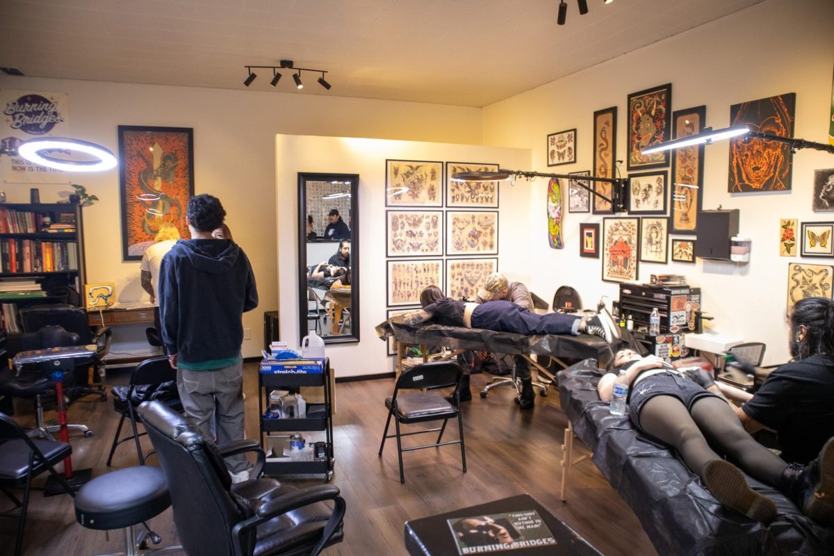 A view of people getting tattooed inside Burning Bridges Tattoos during their first anniversary celebration.