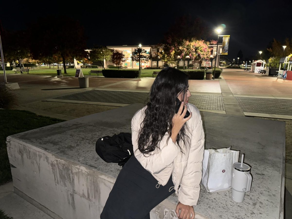 Itzayana Romo (Communication Studies, Senior) sitting in the quad late at night