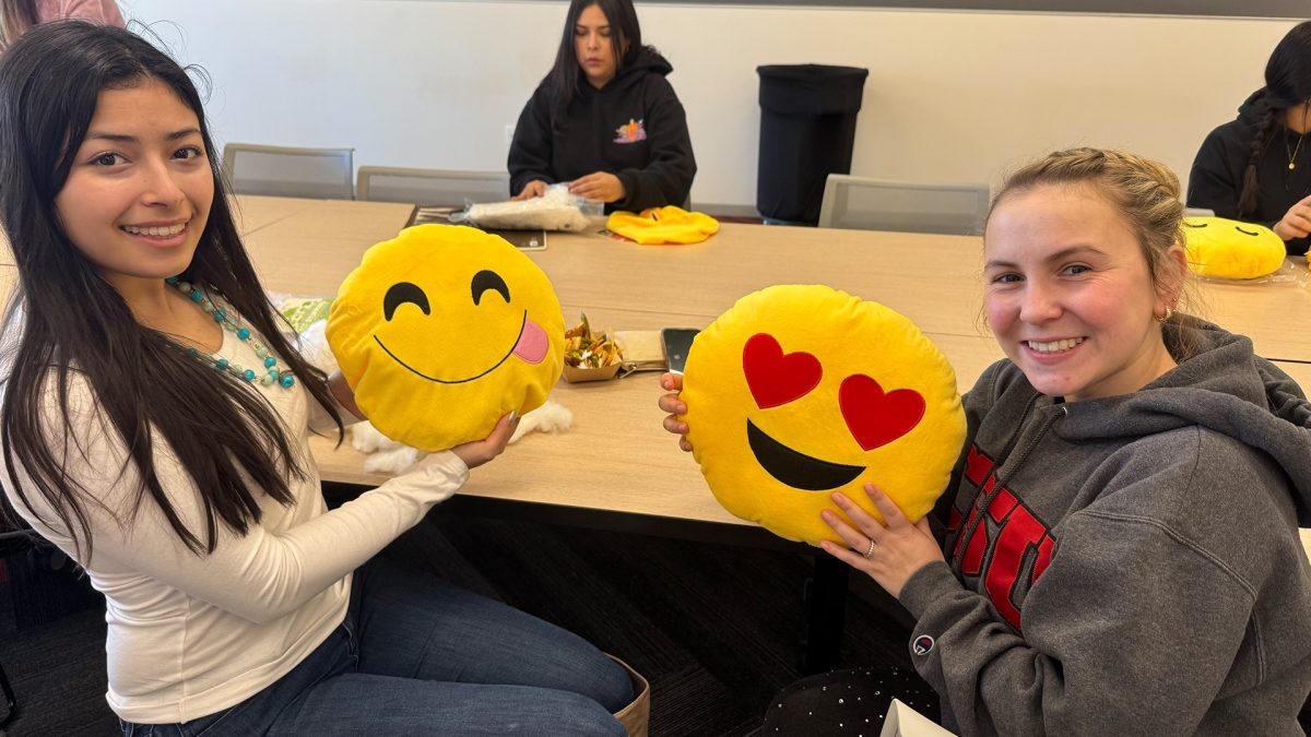 Carmen Garcia (Sophomore, Psychology) (left) and Alexandria Raposo (Administrative Support Coordinator, Psychology) (right) posing with their emoji pillows at the SC Birthday Bash.