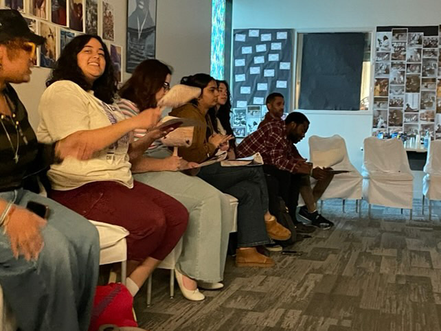 Attendees of the Album Unpacking Party listen to a gospel song while some sing along.