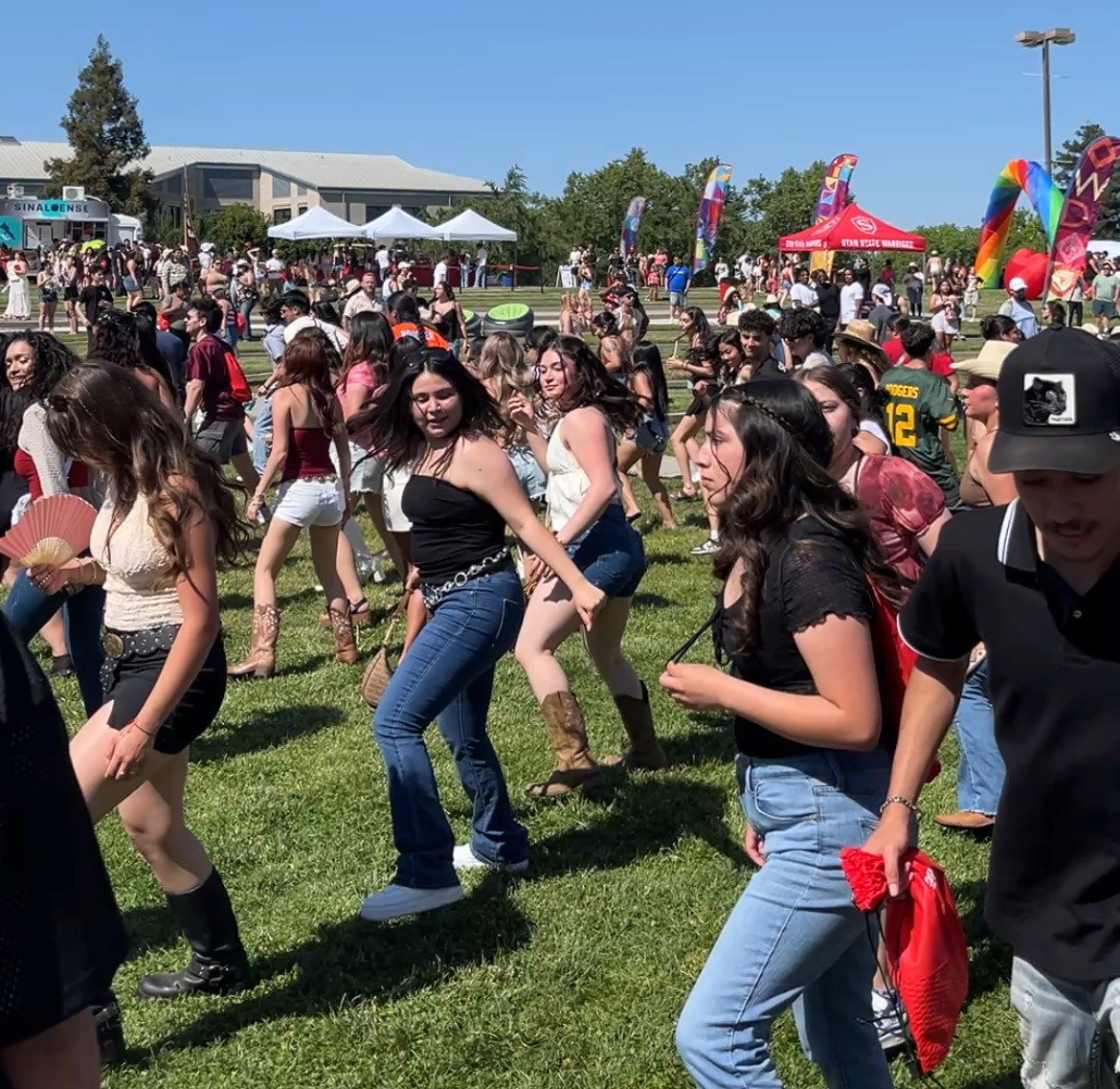 Warrior Day Festival attendees dancing in a group to music.