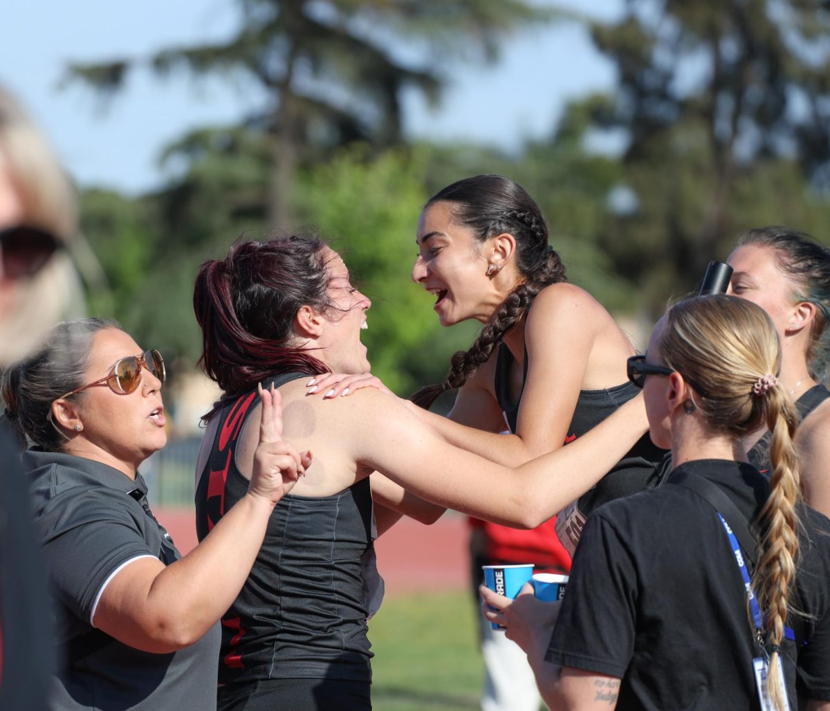 Shaylynn Wynn celebrating their 4x400 results with Mila Real.