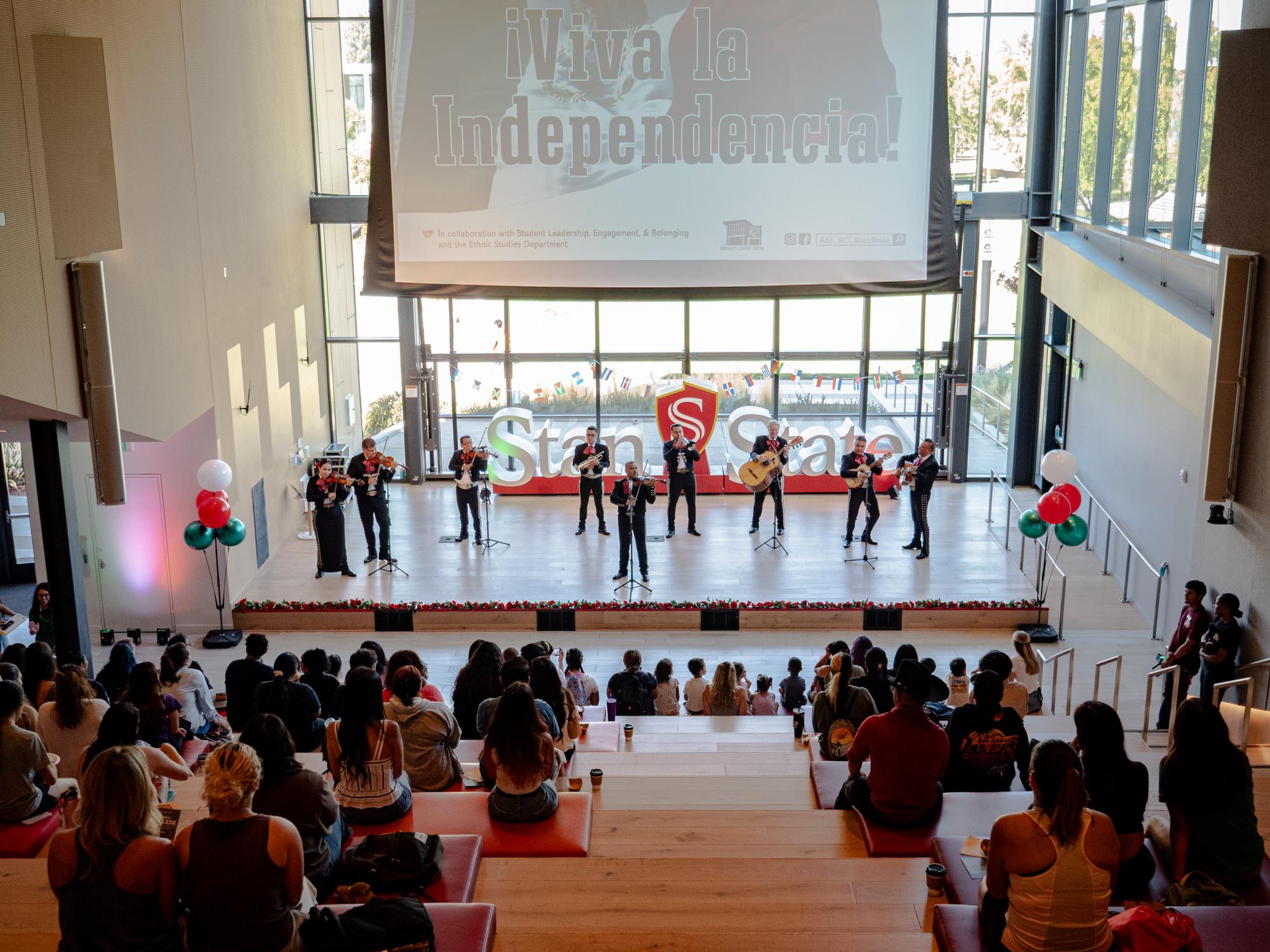 Mariachi Estelar on stage performing to the audience.