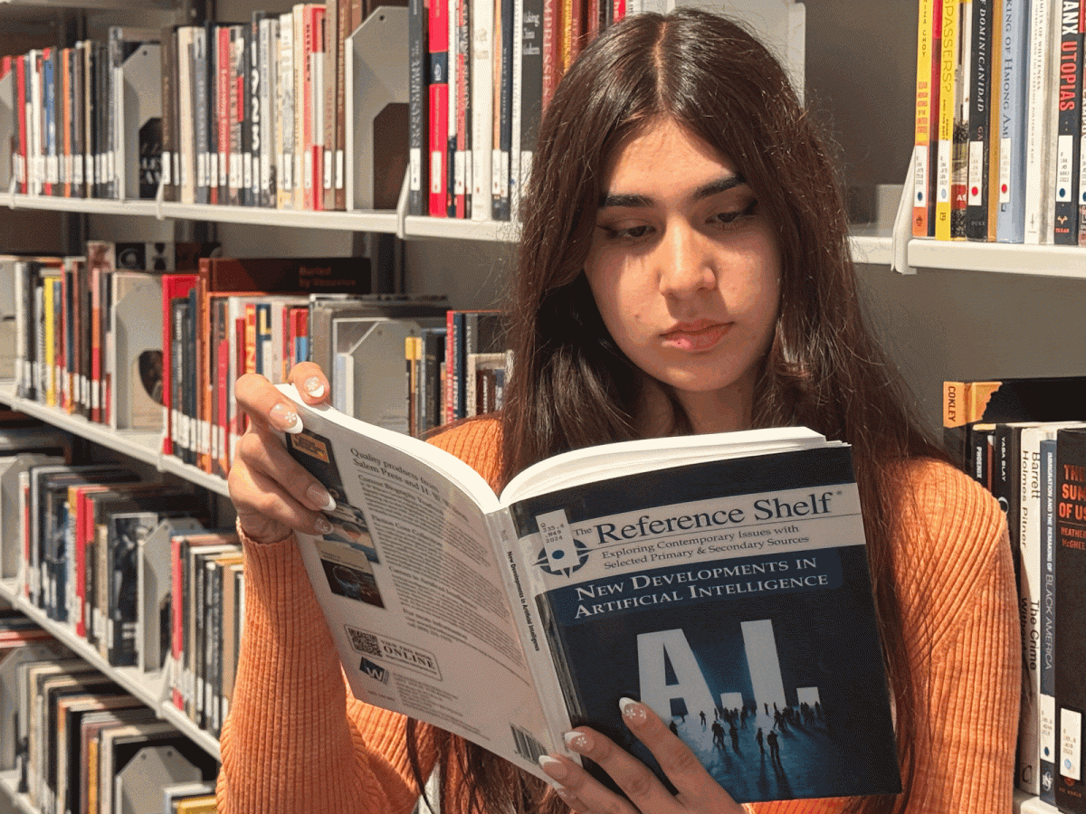 Emaan Nawabi (Freshman, Communications) is reading a book on the developments of AI to learn more