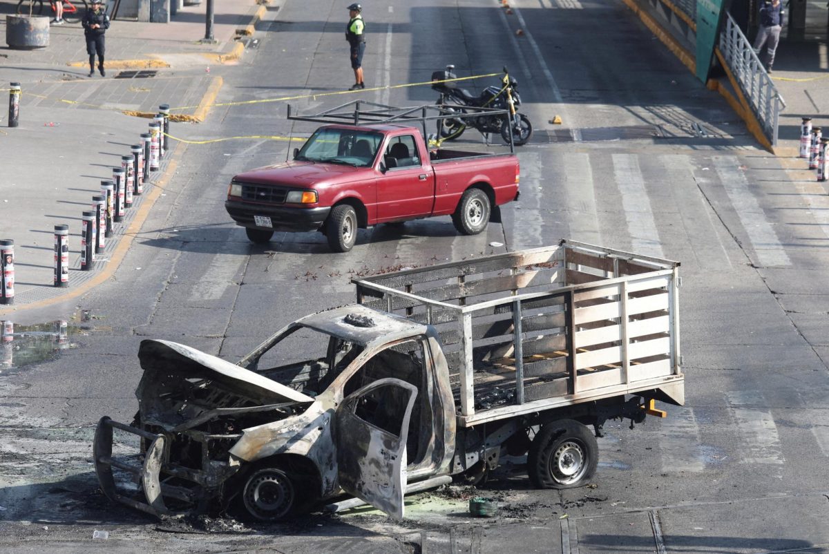 The burned wreckage of a truck, used as a barricade by members of organized crime following a series of detentions by federal forces, lies in Guadalajara, Mexico, February 22, 2026. REUTERS/Michelle Freyria