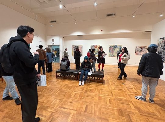 Crowd of attendees viewing Poetic Cartography on February 12, 2026 during open reception at the Stan State Art Gallery.
