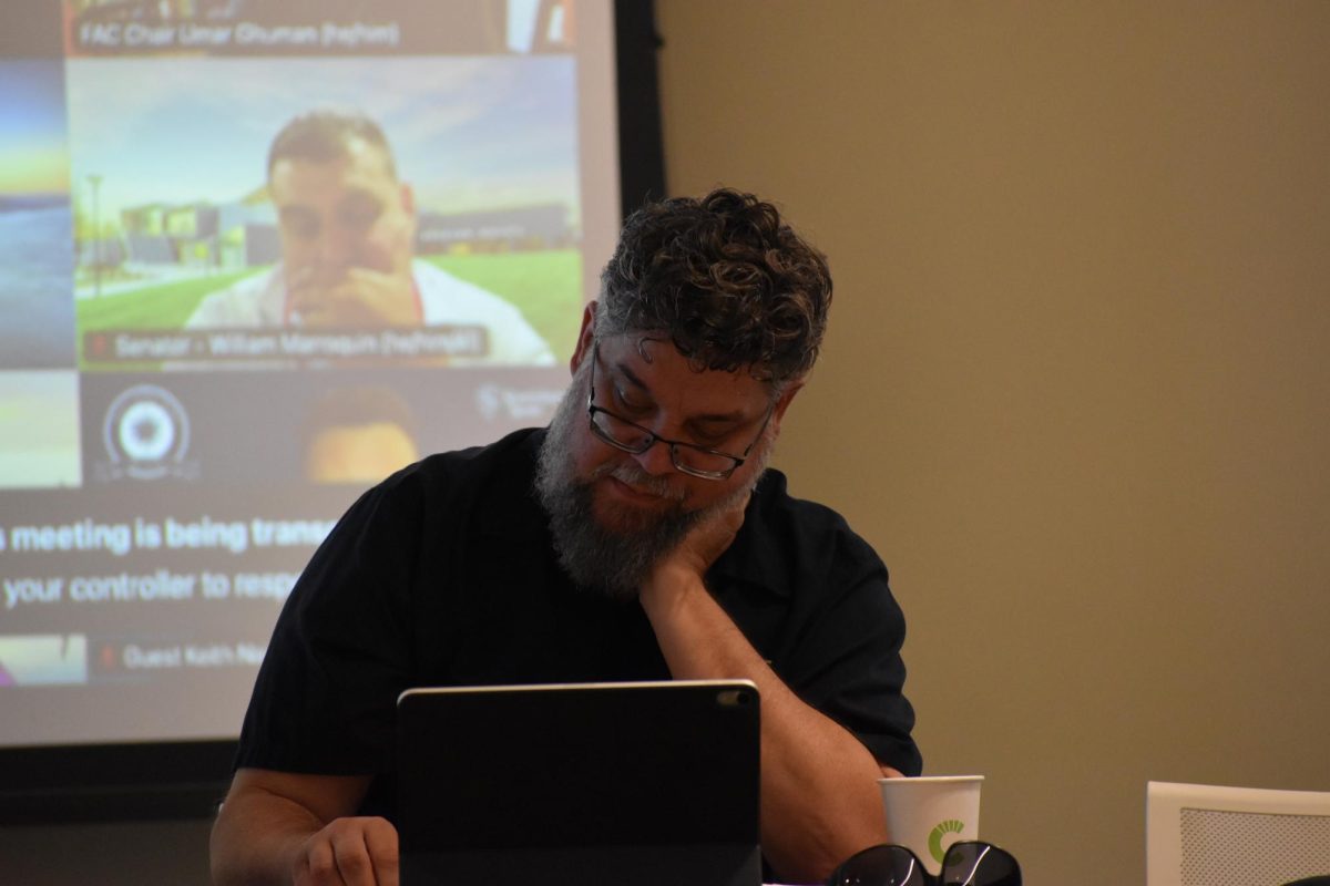 Senator David Martin listening to his fellow senators express their opinions over the reading items at the academic senate meeting on Tuesday, April 14, 2026, in Turlock.