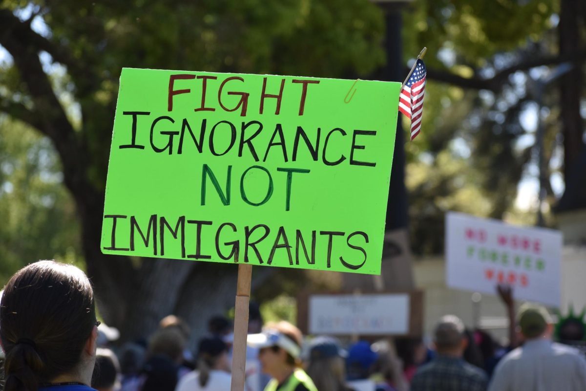 Protestor holds up sign that reads "Fight Ignorance Not immigrants," on Saturday, March 28,  2026 at the protest in Modesto.