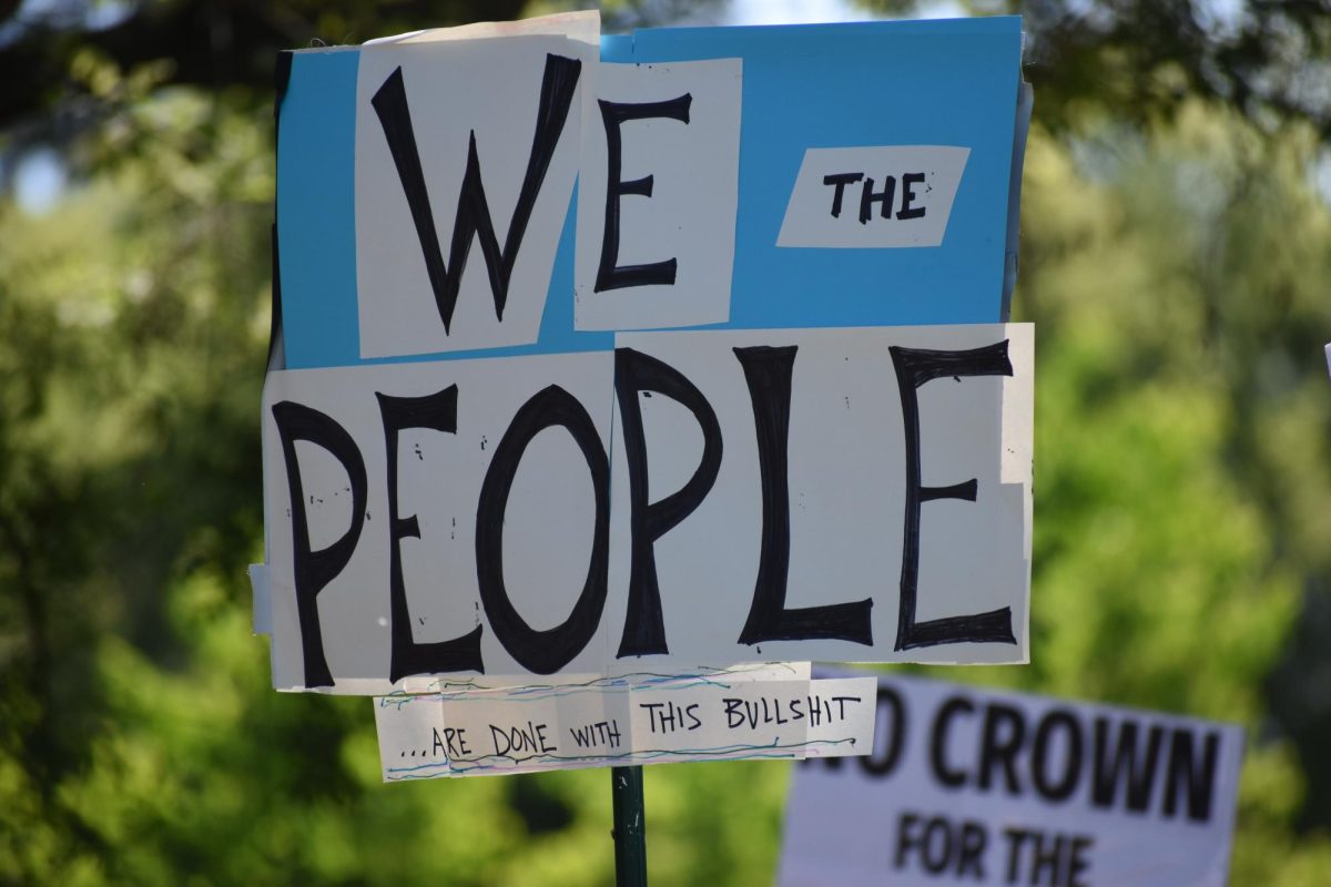 Protestor holds up sign that reads "We the people...are done with this bullshit," on Saturday, March 28,  2026 at the No Kings Protest in Modesto.